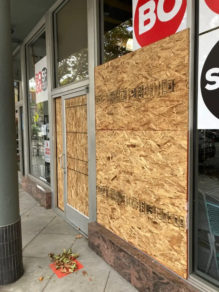 24-hour emergency board-up service: a securely boarded-up window with plywood, providing immediate protection for residential or commercial properties after a break-in or damage